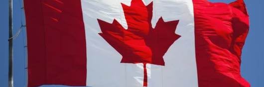 Canada flag against blue sky